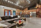 Barn house interior photography, leather sofa, spiral stair, bar table, steel roof, wooden center table,